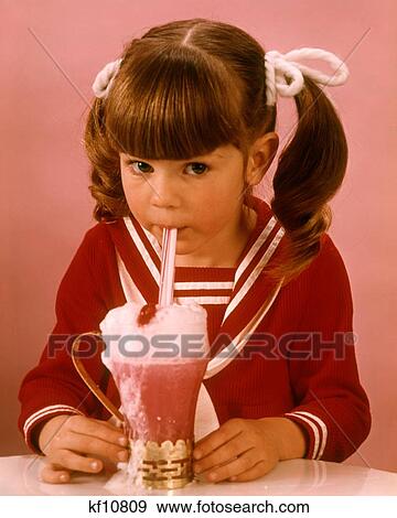 1960S 1970S Brunette Girl Red Blouse Drinking Pink Strawberry Drink Milkshake Ice Cream Soda View Large Photo Image Stock Photo - 1960S 1970S Brunette Girl Red Blouse Drinking Pink Strawberry Drink Milkshake Ice Cream Soda. Fotosearch