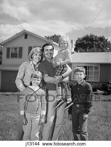 1960s 1970s FAMILY PORTRAIT OF FIVE POSED LOOKING AT CAMERA ON FRONT LAWN OF SUBURBAN HOUSE View Large Photo Image Picture - 1960s 1970s FAMILY PORTRAIT OF FIVE POSED LOOKING AT CAMERA ON FRONT LAWN OF SUBURBAN HOUSE. Fotosearch