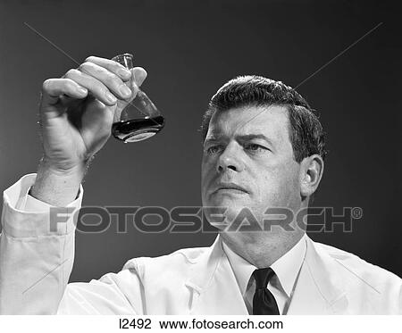 1960s 1970s MAN SCIENTIST HOLDING LOOKING AT GLASS BEAKER OF LIQUID View Large Photo Image Stock Image - 1960s 1970s MAN SCIENTIST HOLDING LOOKING AT GLASS BEAKER OF LIQUID. Fotosearch