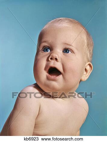 Stock Image - 1960s 1970s PORTRAIT HAPPY BABY MOUTH OPEN FACIAL EXPRESSION OF WONDER. Fotosearch