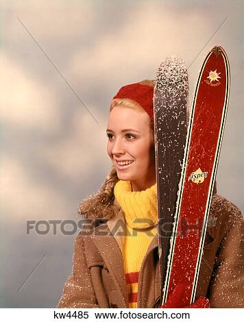 1960S 1970S Portrait Woman Red Headband Yellow Turtleneck Sweater Holding Pair Of Skis Skier View Large Photo Image Stock Photography - 1960S 1970S Portrait Woman Red Headband Yellow Turtleneck Sweater Holding Pair Of Skis Skier. Fotosearch