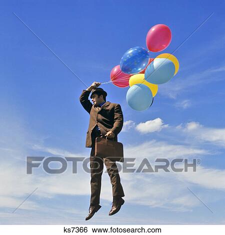 1960s 1970s SALESMAN SUSPENDED MIDAIR BY BUNCH OF MULTI-COLORED HELIUM BALLOONS View Large Photo Image Stock Photograph - 1960s 1970s SALESMAN SUSPENDED MIDAIR BY BUNCH OF MULTI-COLORED HELIUM BALLOONS. Fotosearch
