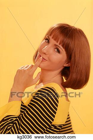 1960s 1970s SEXY YOUNG REDHEAD WOMAN POSING LOOKING AT CAMERA KISSING FINGER TOUCHING LIPS View Large Photo Image Stock Photograph - 1960s 1970s SEXY YOUNG REDHEAD WOMAN POSING LOOKING AT CAMERA KISSING FINGER TOUCHING LIPS. Fotosearch