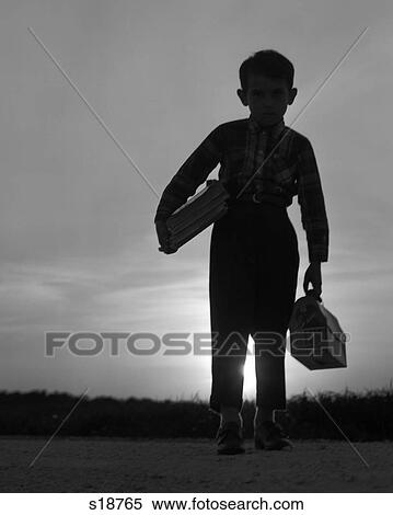 1960s 1970s SILHOUETTE OF ANONYMOUS YOUNG BOY HOLDING BOOKS AND LUNCH PAIL IN RISING MORNING SUN ON WAY TO SCHOOL View Large Photo Image Stock Photography - 1960s 1970s SILHOUETTE OF ANONYMOUS YOUNG BOY HOLDING BOOKS AND LUNCH PAIL IN RISING MORNING SUN ON WAY TO SCHOOL. Fotosearch