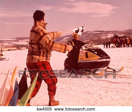 1960S 1970S Snowmobile Race Man Official In Yellow Red Plaid Wool Snow Suit Waving Checkered Winner Finish Flag View Large Photo Image Stock Photography - 1960S 1970S Snowmobile Race Man Official In Yellow Red Plaid Wool Snow Suit Waving Checkered Winner Finish Flag. Fotosearch