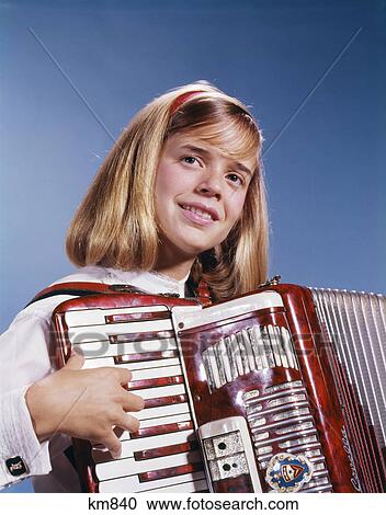 1960s 1970s TEENAGE GIRL SMILING PLAYING ACCORDION View Large Photo Image Stock Image - 1960s 1970s TEENAGE GIRL SMILING PLAYING ACCORDION. Fotosearch