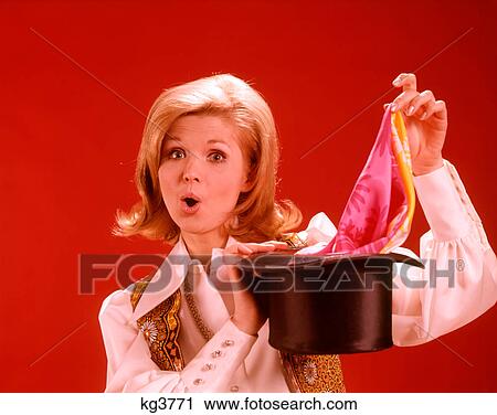 1960s 1970s WOMAN MAGICIAN LOOKING AT CAMERA PULLING SCARF OUT OF TOP HAT View Large Photo Image Stock Image - 1960s 1970s WOMAN MAGICIAN LOOKING AT CAMERA PULLING SCARF OUT OF TOP HAT. Fotosearch