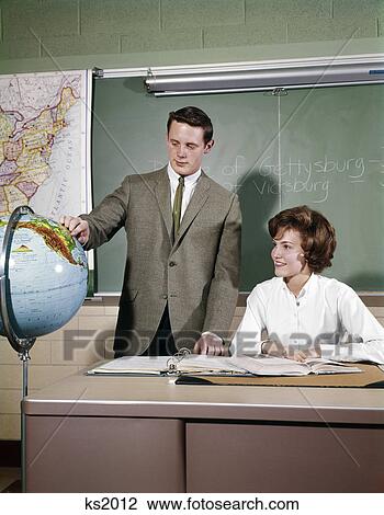 1960s 2 STUDENTS IN CLASSROOM TEEN BOY STAND BY GLOBE GIRL SEATED AT DESK MAP CHALKBOARD HIGH SCHOOL View Large Photo Image Stock Image - 1960s 2 STUDENTS IN CLASSROOM TEEN BOY STAND BY GLOBE GIRL SEATED AT DESK MAP CHALKBOARD HIGH SCHOOL. Fotosearch