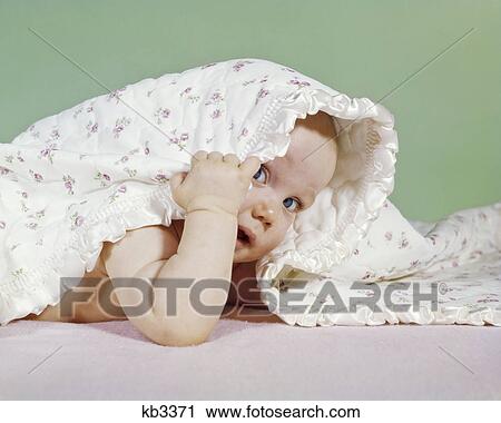 1960s BABY HIDING UNDER BLANKET LOOKING OUT LOOKING AT CAMERA View Large Photo Image Stock Image - 1960s BABY HIDING UNDER BLANKET LOOKING OUT LOOKING AT CAMERA. Fotosearch