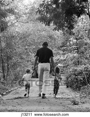 1960S Back View Father Holding Hands With Two Children Son And Daughter Walking Woodland Trail View Large Photo Image Stock Image - 1960S Back View Father Holding Hands With Two Children Son And Daughter Walking Woodland Trail . Fotosearch