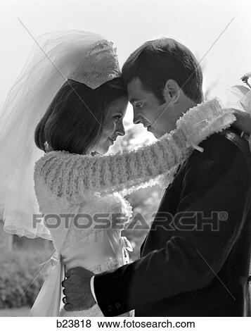 1960S Backlit Couple Bride Groom Embracing Head To Head Foreheads Touching View Large Photo Image Stock Photo - 1960S Backlit Couple Bride Groom Embracing Head To Head Foreheads Touching . Fotosearch