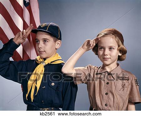1960s BOY AND GIRL IN CUB SCOUT AND BROWNIE UNIFORMS STANDING BY AMERICAN FLAG SALUTING View Large Photo Image Stock Image - 1960s BOY AND GIRL IN CUB SCOUT AND BROWNIE UNIFORMS STANDING BY AMERICAN FLAG SALUTING. Fotosearch