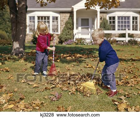 1960s BOY GIRL RAKING AUTUMN LEAVES IN YARD SUBURBAN HOUSE IN BACKGROUND View Large Photo Image Stock Photo - 1960s BOY GIRL RAKING AUTUMN LEAVES IN YARD SUBURBAN HOUSE IN BACKGROUND. Fotosearch