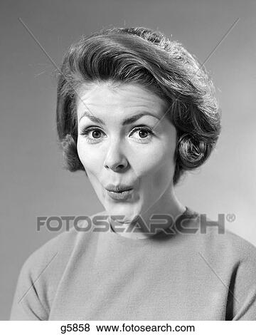 1960s BRUNETTE WOMAN WITH SURPRISED FACIAL EXPRESSION WHISTLING WITH LIPS PUCKERED LOOKING AT CAMERA View Large Photo Image Stock Photo - 1960s BRUNETTE WOMAN WITH SURPRISED FACIAL EXPRESSION WHISTLING WITH LIPS PUCKERED LOOKING AT CAMERA. Fotosearch