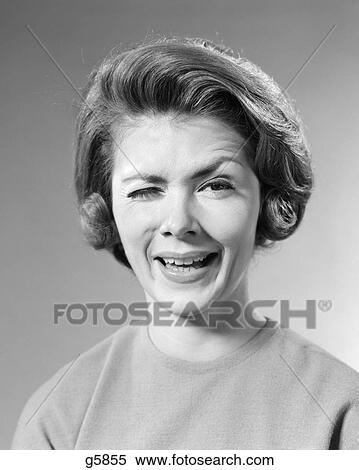 1960s BRUNETTE WOMAN WITH WACKY FUNNY FACIAL EXPRESSION WINKING ONE EYE LOOKING AT CAMERA View Large Photo Image Stock Photography - 1960s BRUNETTE WOMAN WITH WACKY FUNNY FACIAL EXPRESSION WINKING ONE EYE LOOKING AT CAMERA. Fotosearch