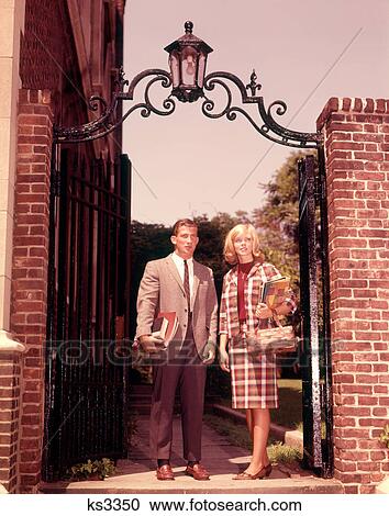 1960s COLLEGE COUPLE STANDING BRICK IRON GATES CAMPUS UNIVERSITY View Large Photo Image Stock Image - 1960s COLLEGE COUPLE STANDING BRICK IRON GATES CAMPUS UNIVERSITY. Fotosearch
