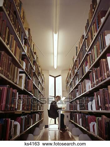 1960s COLLEGE MAN STUDYING AT END OF LIBRARY BOOK STACK View Large Photo Image Stock Image - 1960s COLLEGE MAN STUDYING AT END OF LIBRARY BOOK STACK. Fotosearch