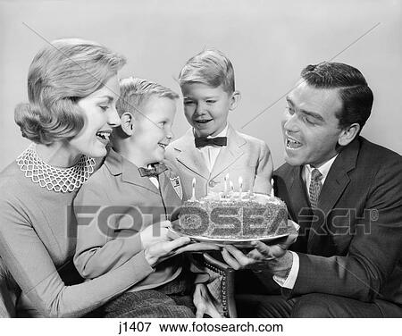 1960s FAMILY AROUND A BIRTHDAY CAKE CANDLES SINGING TO BOY View Large Photo Image Stock Photo - 1960s FAMILY AROUND A BIRTHDAY CAKE CANDLES SINGING TO BOY. Fotosearch