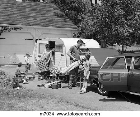 1960s FAMILY OF 5 LOADING CAR & TRAILER WITH LAWN CHAIRS & SPORTS EQUIPMENT View Large Photo Image Picture - 1960s FAMILY OF 5 LOADING CAR & TRAILER WITH LAWN CHAIRS & SPORTS EQUIPMENT. Fotosearch