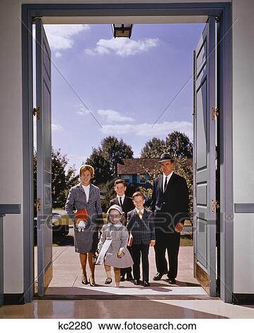 1960s Family Of Five Walking In The Front Door Of Church Looking
