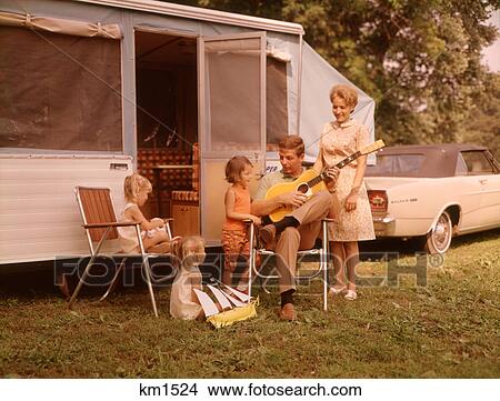 1960s FAMILY VACATION RV POP-UP CAMPER MOTHER THREE CHILDREN ALL GIRLS FATHER SITTING PLAYING GUITAR View Large Photo Image Picture - 1960s FAMILY VACATION RV POP-UP CAMPER MOTHER THREE CHILDREN ALL GIRLS FATHER SITTING PLAYING GUITAR. Fotosearch