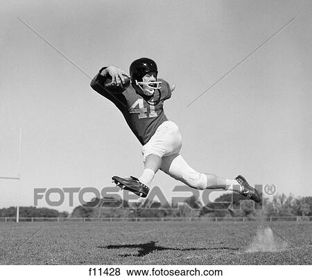 1960S Football Player Running Carrying Ball View Large Photo Image Stock Photo - 1960S Football Player Running Carrying Ball. Fotosearch