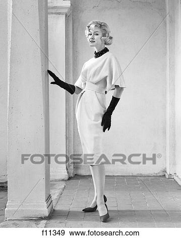 1960s FULL LENGTH PORTRAIT ELEGANT BLONDE WOMAN WEARING DRESS WITH FULL DRAPED SLEEVES LONG GLOVES POSING BY COLUMN OUTDOORS View Large Photo Image Stock Photo - 1960s FULL LENGTH PORTRAIT ELEGANT BLONDE WOMAN WEARING DRESS WITH FULL DRAPED SLEEVES LONG GLOVES POSING BY COLUMN OUTDOORS. Fotosearch