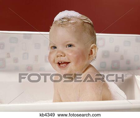 1960s HAPPY BABY IN BATH WITH SOAP SUDS ON TOP OF HEAD View Large Photo Image Stock Photo - 1960s HAPPY BABY IN BATH WITH SOAP SUDS ON TOP OF HEAD. Fotosearch