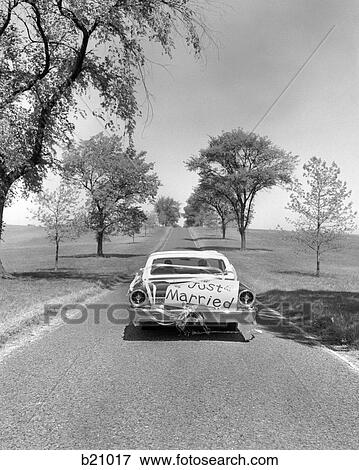 1960s JUST MARRIED BRIDE AND GROOM DRIVING AWAY IN CAR View Large Photo Image Stock Photo - 1960s JUST MARRIED BRIDE AND GROOM DRIVING AWAY IN CAR. Fotosearch