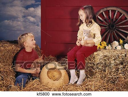 1960s LITTLE BOY AND GIRL BROTHER AND SISTER IN FARM SETTING HOLDING KITTENS View Large Photo Image Stock Image - 1960s LITTLE BOY AND GIRL BROTHER AND SISTER IN FARM SETTING HOLDING KITTENS. Fotosearch