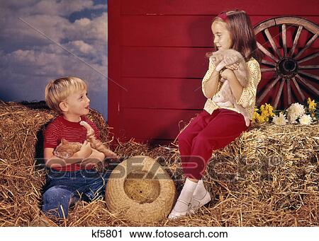 1960s LITTLE BOY AND GIRL BROTHER AND SISTER IN FARM SETTING HOLDING KITTENS View Large Photo Image Stock Image - 1960s LITTLE BOY AND GIRL BROTHER AND SISTER IN FARM SETTING HOLDING KITTENS. Fotosearch