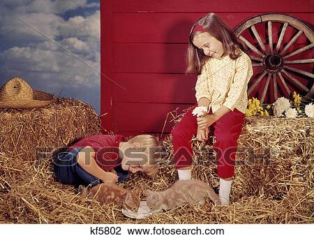 1960s LITTLE BOY AND GIRL BROTHER AND SISTER IN FARM BARN SETTING WATCHING KITTENS DRINKING MILK View Large Photo Image Stock Image - 1960s LITTLE BOY AND GIRL BROTHER AND SISTER IN FARM BARN SETTING WATCHING KITTENS DRINKING MILK. Fotosearch