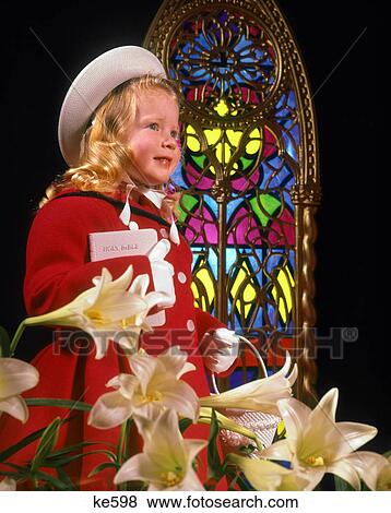 1960s LITTLE GIRL IN CHURCH HOLDING WHITE BIBLE WEARING HAT RED COAT STAINED GLASS WHITE LILIES View Large Photo Image Stock Photo - 1960s LITTLE GIRL IN CHURCH HOLDING WHITE BIBLE WEARING HAT RED COAT STAINED GLASS WHITE LILIES. Fotosearch