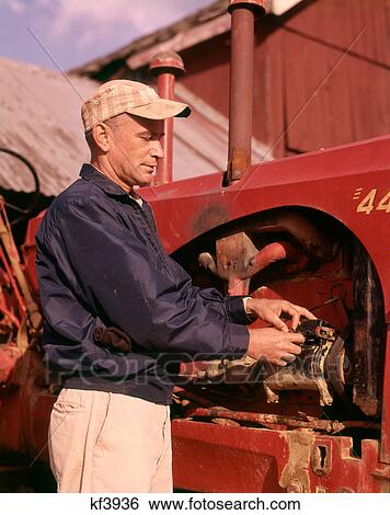 1960s MAN FARMER REPAIRING TRACTOR FARM EQUIPMENT MACHINERY View Large Photo Image Stock Photograph - 1960s MAN FARMER REPAIRING TRACTOR FARM EQUIPMENT MACHINERY. Fotosearch