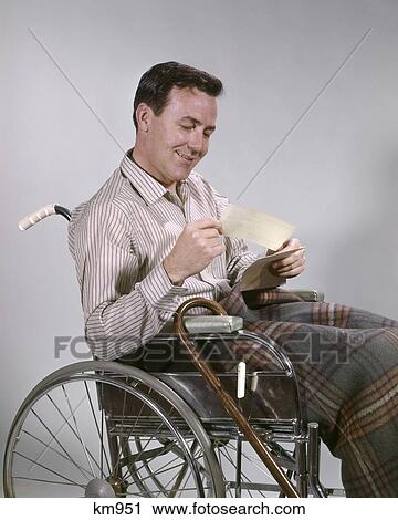 1960S Man Sitting In Wheelchair Holding Reading Insurance Check View Large Photo Image Stock Image - 1960S Man Sitting In Wheelchair Holding Reading Insurance Check. Fotosearch