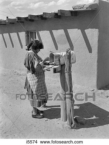 1960S Native American Woman Getting Mail From Mailbox San Ildefonso Pueblo New Mexico View Large Photo Image Picture - 1960S Native American Woman Getting Mail From Mailbox San Ildefonso Pueblo New Mexico . Fotosearch