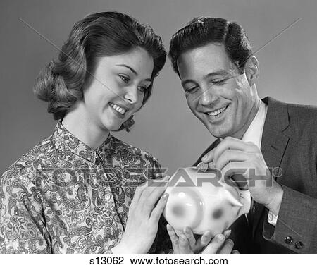 1960s PORTRAIT OF COUPLE PUTTING MONEY INTO PIGGY BANK View Large Photo Image Stock Image - 1960s PORTRAIT OF COUPLE PUTTING MONEY INTO PIGGY BANK. Fotosearch