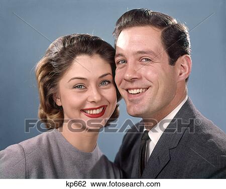 1960s PORTRAIT SMILING HAPPY COUPLE MAN WOMAN PORTRAIT HUSBAND AND WIFE HEAD TO HEAD LOOKING AT CAMERA View Large Photo Image Stock Image - 1960s PORTRAIT SMILING HAPPY COUPLE MAN WOMAN PORTRAIT HUSBAND AND WIFE HEAD TO HEAD LOOKING AT CAMERA. Fotosearch