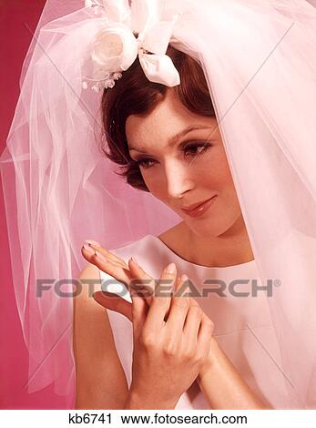 1960s PORTRAIT THOUGHTFUL BRIDE ADMIRING HER HANDS AND NEW WEDDING RING View Large Photo Image Stock Image - 1960s PORTRAIT THOUGHTFUL BRIDE ADMIRING HER HANDS AND NEW WEDDING RING. Fotosearch