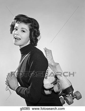 1960S Profile Of Smiling Brunette Looking At Camera With Pair Of Roller Skates Slung Over Shoulder View Large Photo Image Stock Photography - 1960S Profile Of Smiling Brunette Looking At Camera With Pair Of Roller Skates Slung Over Shoulder. Fotosearch