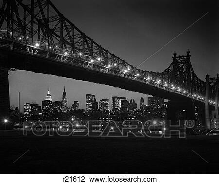 Stock Image - 1960S Queensboro Bridge And Manhattan Skyline At Night New York City Ny Usa . Fotosearch