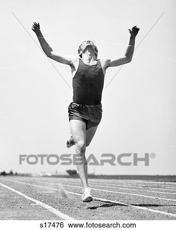 1960s RUNNER STRAINING TO BREAK TAPE AT FINISH OF RACE View Large Photo Image Stock Photograph - 1960s RUNNER STRAINING TO BREAK TAPE AT FINISH OF RACE. Fotosearch