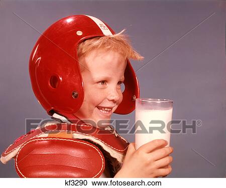 1960s SMILING BLOND BOY RED PLASTIC FOOTBALL HELMET SHOULDER PADS HOLDING GLASS OF MILK View Large Photo Image Stock Image - 1960s SMILING BLOND BOY RED PLASTIC FOOTBALL HELMET SHOULDER PADS HOLDING GLASS OF MILK. Fotosearch