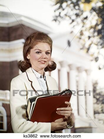 1960s SMILING COLLEGE GIRL COED HOLDING BOOKS STANDING IN FRONT OF CAMPUS BUILDING View Large Photo Image Stock Image - 1960s SMILING COLLEGE GIRL COED HOLDING BOOKS STANDING IN FRONT OF CAMPUS BUILDING. Fotosearch