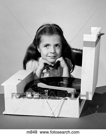 Stock Photo - 1960S Smiling Juvenile Girl Listening To Record Player 33Rpm Vinyl Record . Fotosearch