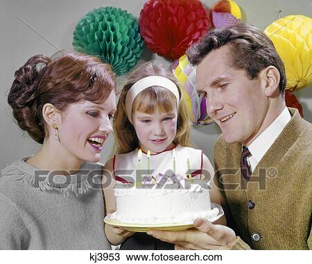 1960s SMILING MOTHER AND FATHER WITH DAUGHTER READY TO BLOW OUT CANDLES ON BIRTHDAY CAKE PARTY DECORATIONS View Large Photo Image Stock Image - 1960s SMILING MOTHER AND FATHER WITH DAUGHTER READY TO BLOW OUT CANDLES ON BIRTHDAY CAKE PARTY DECORATIONS. Fotosearch