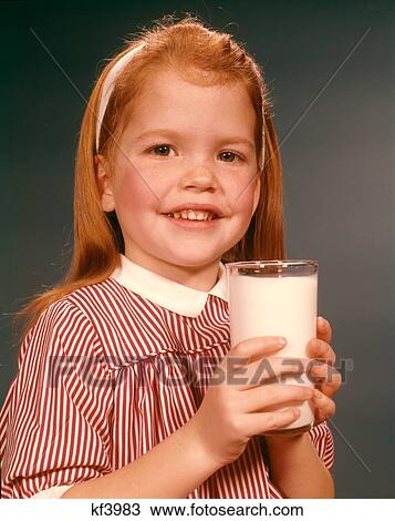 1960s SMILING PORTRAIT OF BLONDE GIRL HOLDING DRINKING GLASS FULLOF MILK LOOKING AT CAMERA View Large Photo Image Stock Image - 1960s SMILING PORTRAIT OF BLONDE GIRL HOLDING DRINKING GLASS FULLOF MILK LOOKING AT CAMERA. Fotosearch