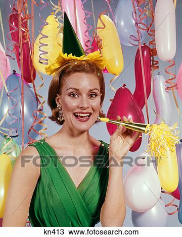 1960s SMILING WOMAN LOOKING AT CAMERA AMID STREAMERS AND BALLOONS HOLDING NEW YEARS NOISE MAKER View Large Photo Image Stock Image - 1960s SMILING WOMAN LOOKING AT CAMERA AMID STREAMERS AND BALLOONS HOLDING NEW YEARS NOISE MAKER. Fotosearch