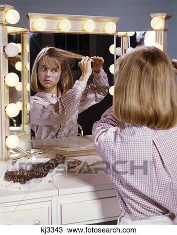 1960s TEENAGE GIRL SITTING AT MAKEUP MIRROR STYLING HER HAIR View Large Photo Image Stock Image - 1960s TEENAGE GIRL SITTING AT MAKEUP MIRROR STYLING HER HAIR. Fotosearch