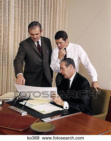 1960S Three Executive Men Meeting Discussing Paperwork Plans View Large Photo Image Stock Photo - 1960S Three Executive Men Meeting Discussing Paperwork Plans . Fotosearch